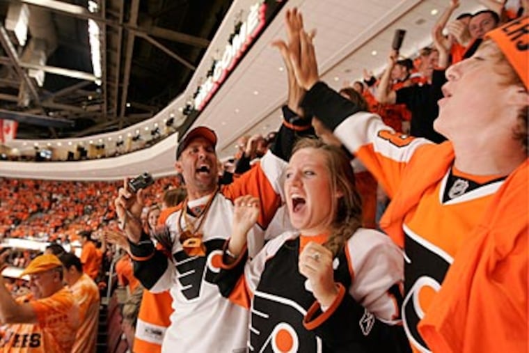 Flyers fans in the 200-level celebrate a goal in the first period of Game 4 of the Stanley Cup Finals. (Michael Bryant / Staff Photographer)
