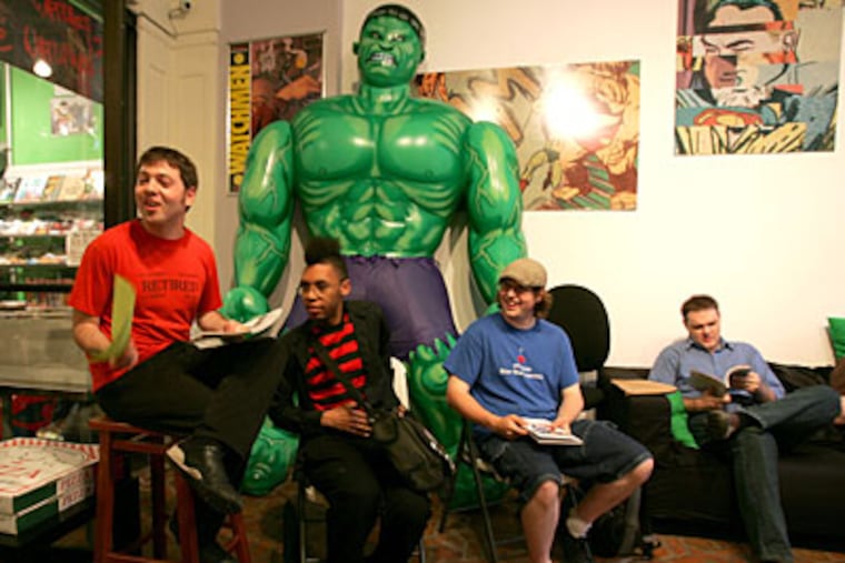 Comic book fans (from left) Robert LeFevre, Larry West, Matt Johnson, and Shawn McKinney dissect "The Nightly News." (David Swanson / Staff Photographer)