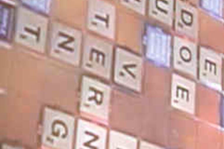 Deputy Police Commissioner Charlotte Council waits to take her turn against Fire Commissioner Lloyd M. Ayers during the start of "Philly Plays Scrabble" at the Central Library of the Free Library of Philadelphia. The effort seeks to get youths playing. Story, B2.