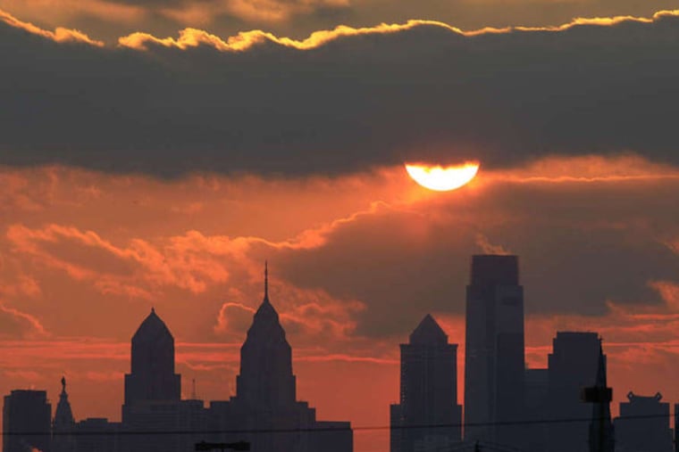 File - The sun is seen low in the sky before it sets behind the city skyline Friday, Jan. 14, 2011. (AP Photo/Matt Rourke)