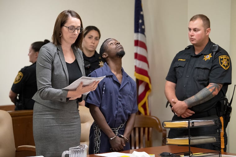 A defendant charged in a robbery linked to murder appears for his detention hearing next to his public defender, Margaret Butler, at the Camden County Superior Court.