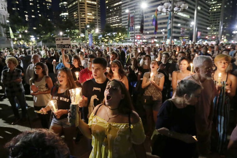 Angela Bassetti of Deptford (foreground) at a rally near City Hall in Philadelphia, one of several protests in the region sparked by the deaths and violence linked to a gathering by white nationalists in Charlottesville, Va.