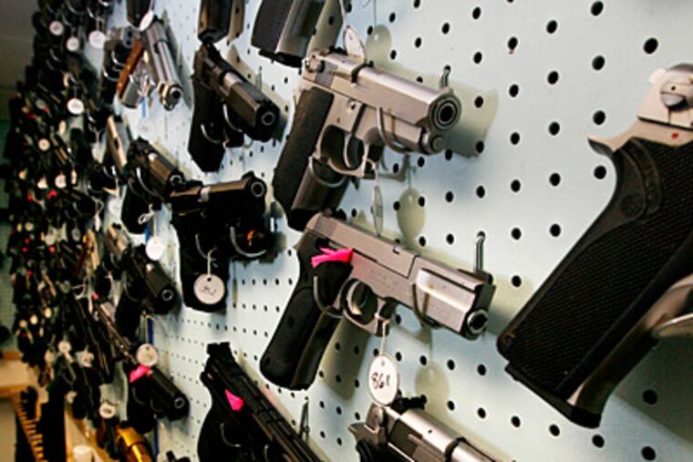 Guns line a wall in the Police Dept.'s Firearms Identification Unit. (Alejandro A. Alvarez/Staff)