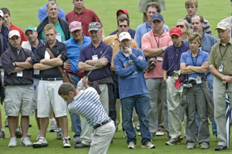 Sam Hutsby of the Great Britain and Ireland team takes a shot on Merion Golf Club’s seventh fairway, his every move examined by the gallery walking the course with the players. (Clem Murray / Staff Photographer)