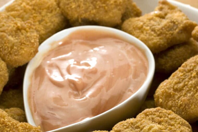 Healthful nuggets can be made at home by baking - not frying - the chicken pieces after coating them with bread or pretzel crumbs or cornflakes. (LARRY CROWE / Associated Press)