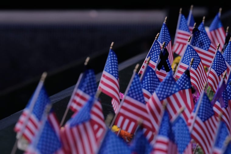 Flags decorate names inscribed at the 9/11 Memorial before the start of a ceremony commemorating the 24th anniversary of the Sept. 11, 2001, attacks last year.