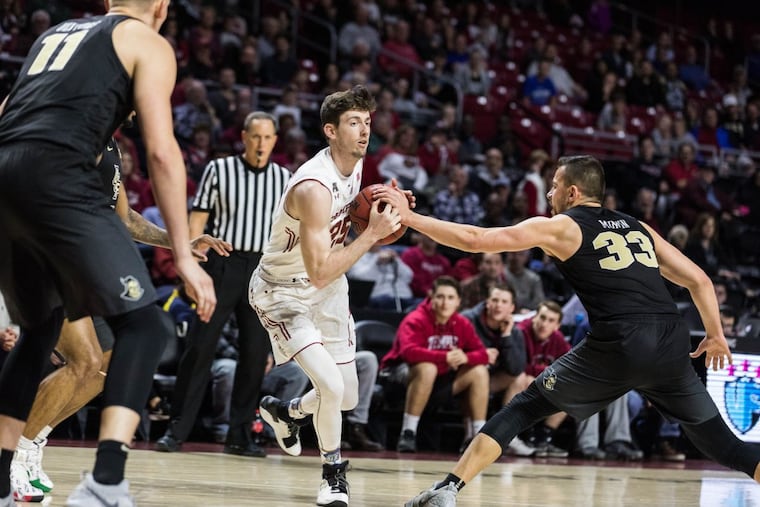 Redshirt-senior forward Steve Leonard keeps the ball from UCF senior guard Djordjije Mumin during the second half of Temple's 75-56 win over UCF at The Liacouras Center on Sunday, February 25, 2018. SYDNEY SCHAEFER / Staff Photographer