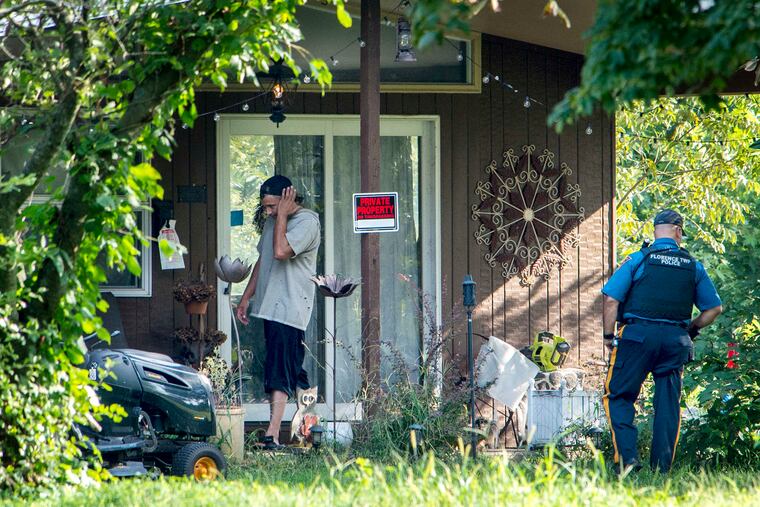 Mark DÕAmico.stands outside the house he shares with Kate McClure in Florence Township as a policeman stands guard while police execute search warrant September 6, 2018 looking for evidence in the disappearance of $400,000 in GoFundMe money meant for Johnny Bobbitt, Jr, the drug-addictd homeless man the couple befriended earlier this year.