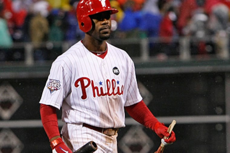 Jimmy Rollins walks back to the dugout with the two pieces of his bat after making the last out of Game 3. (Ron Cortes/ Staff photographer)