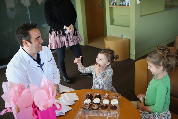 Sisters Chloe (right), 8, and Joelle Davidson (center), 4, of Haddon Heights, N.J., have cupcakes during an early birthday celebration with Dr. Eric Grossman (left). By coincidence, Dr. Grossman, who was born on a leap day, delivered both Chloe and Joelle on leap days as well.