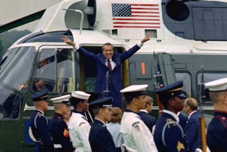 President Richard Nixon says goodbye outside the White House Friday, August 9, 1974 as he prepares to board a helicopter for a flight to nearby Andrews Air Force Base. Nixon addressed members of his staff in the East Room prior to his departure.