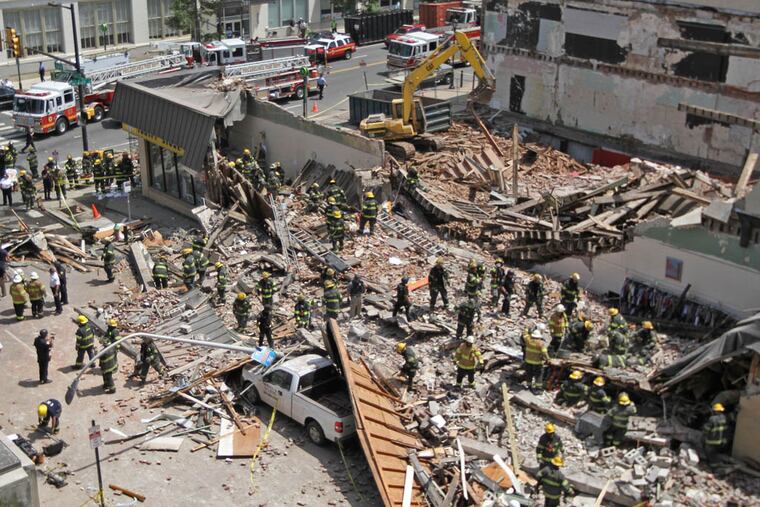 Six people died and 13 were injured when a wall from a building that was being torn down fell onto a store at 22d and Market Streets.