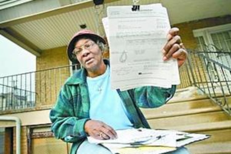 Mary Gay with some paperwork that bears an expensive bottom line: she supposedly owes $48,000.