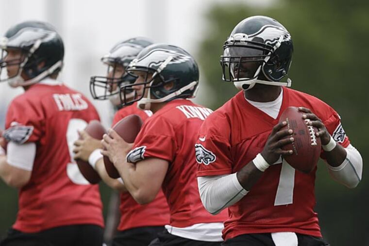 Philadelphia Eagles quarterbacks from right, Michael Vick, G.J. Kinne, and Matt Barkley, and Nick Foles drop back to pass during practice at the team's NFL football training facility, Monday, May 20, 2013, in Philadelphia. (Matt Rourke/AP)