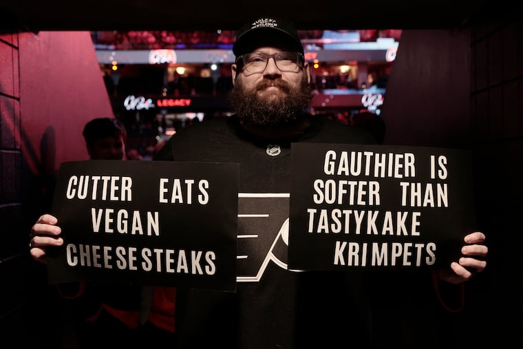 Brian Rousis of Warminster held up two signs for Anaheim’s Cutter Gauthier during warmups Tuesday night before the Ducks faced the Flyers.