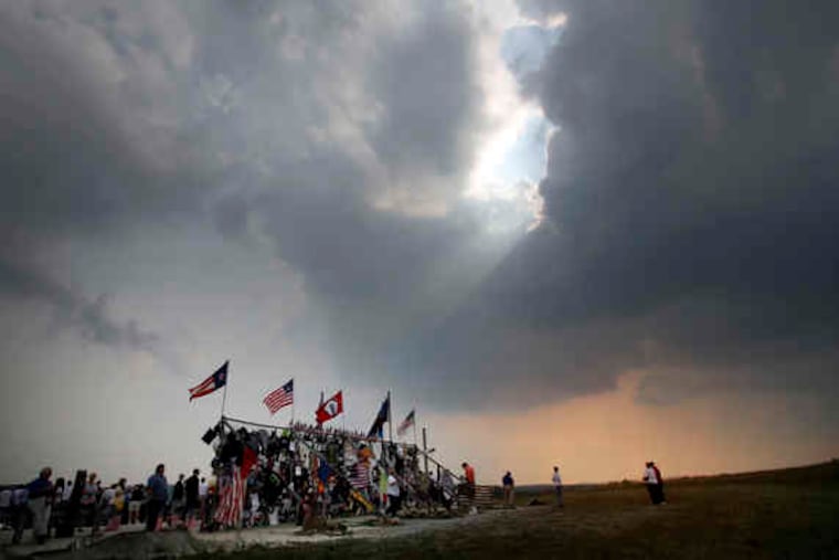 2006: The late-afternoon sun peeks through the clouds at a temporary memorial at the crash site on the day before the fifth anniversary.