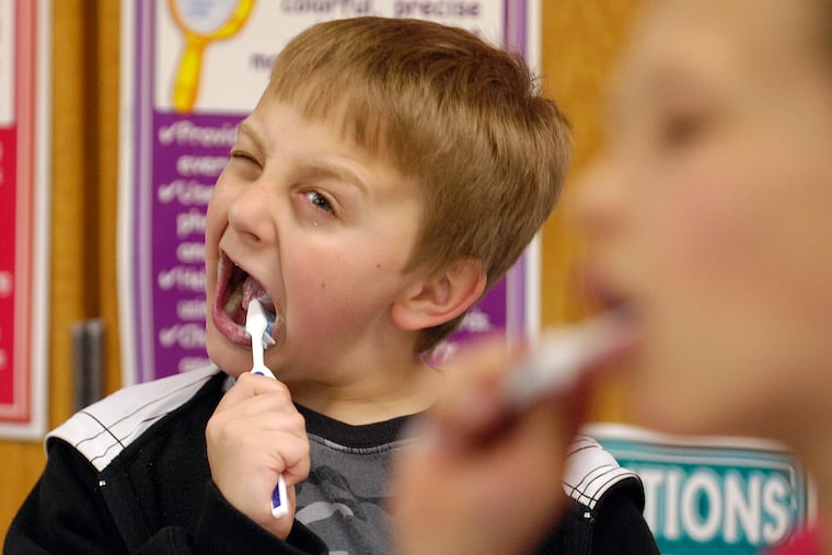 In this March 12, 2010 photo. McDonald Elementary third-grader David Taylor,9, really gets into brushing his teeth after lunch in Moscow, Idaho, as part of School Smiles, a program started by Dentist Rich Bailey to help promote dental health. (AP Photo/Kyle Mills)
