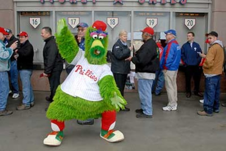 Oblivious to the Phanatic's antics, fans stand in line at Citizens Bank Park early Thursday as Phillies tickets go on sale for the 2009 season. (Tom Gralish / Staff Photographer)