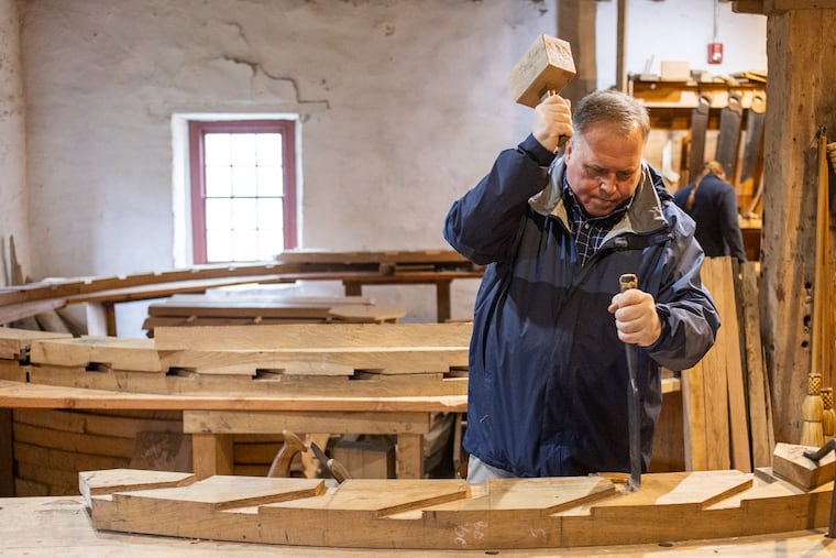 Tony Shahan, executive director, cuts the shape of the wheel frame so that the boards will fit into it properly in Glen Mills, Pa., on Friday, April 11, 2025.