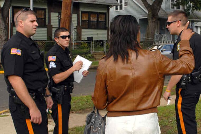 After a burglary call, a witness talks with Woodlynne Officers (from left) Walter Schilling, Charles Amicone, and David Hinton.