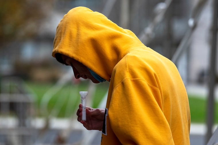 Jason Burke from Middletown takes a saliva test last year. New Jersey is offering free tests to residents.