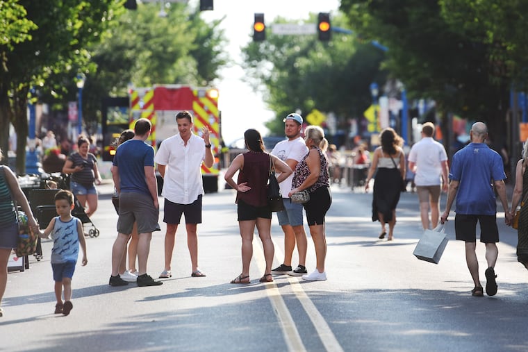 Bridge Street in downtown Phoenixville, Pa. is closed to car traffic every week end and open to foot traffic allowing for outdoor venues of dining, shopping, frequenting restaurants, bars, and people watching. Hundreds of people drawn to Bridge Street checking out the summer scene Friday July 1, 2022 in Phoenixville, Pa.