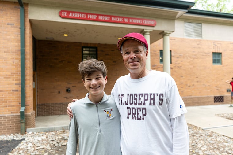 Michael Andrew Kain, 16, Junior Coxswain at Saint Joseph’s Prep, and his dad Michael Patrick Kain, Coxswain for Saint Joseph’s Prep back in 1990, during the first day of the Stotesbury Regatta.