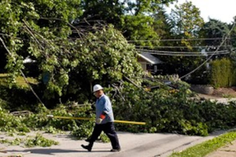 Peco employee Dave Sexton checks on downed wires he noticed in Abington while on his way home from an all-nighter to help restore power for nearly 70,000 customers. He alerted his office.