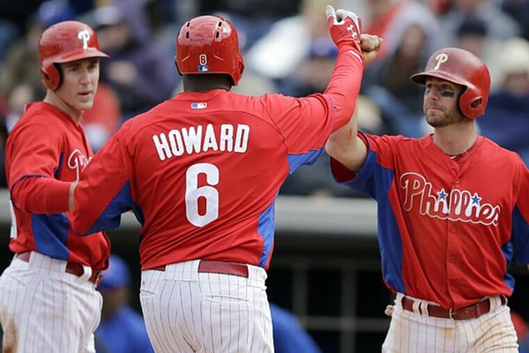 Philadelphia Phillies' Ryan Howard, center, celebrates with teammates
Kevin Frandsen, right, and Chase Utley after hitting a three-run home
run during the fifth inning of a spring training exhibition baseball
game against the Toronto Blue Jays, Sunday, March 3, 2013, in
Clearwater, Fla. Philadelphia won 13-5. (AP Photo/Matt Slocum)