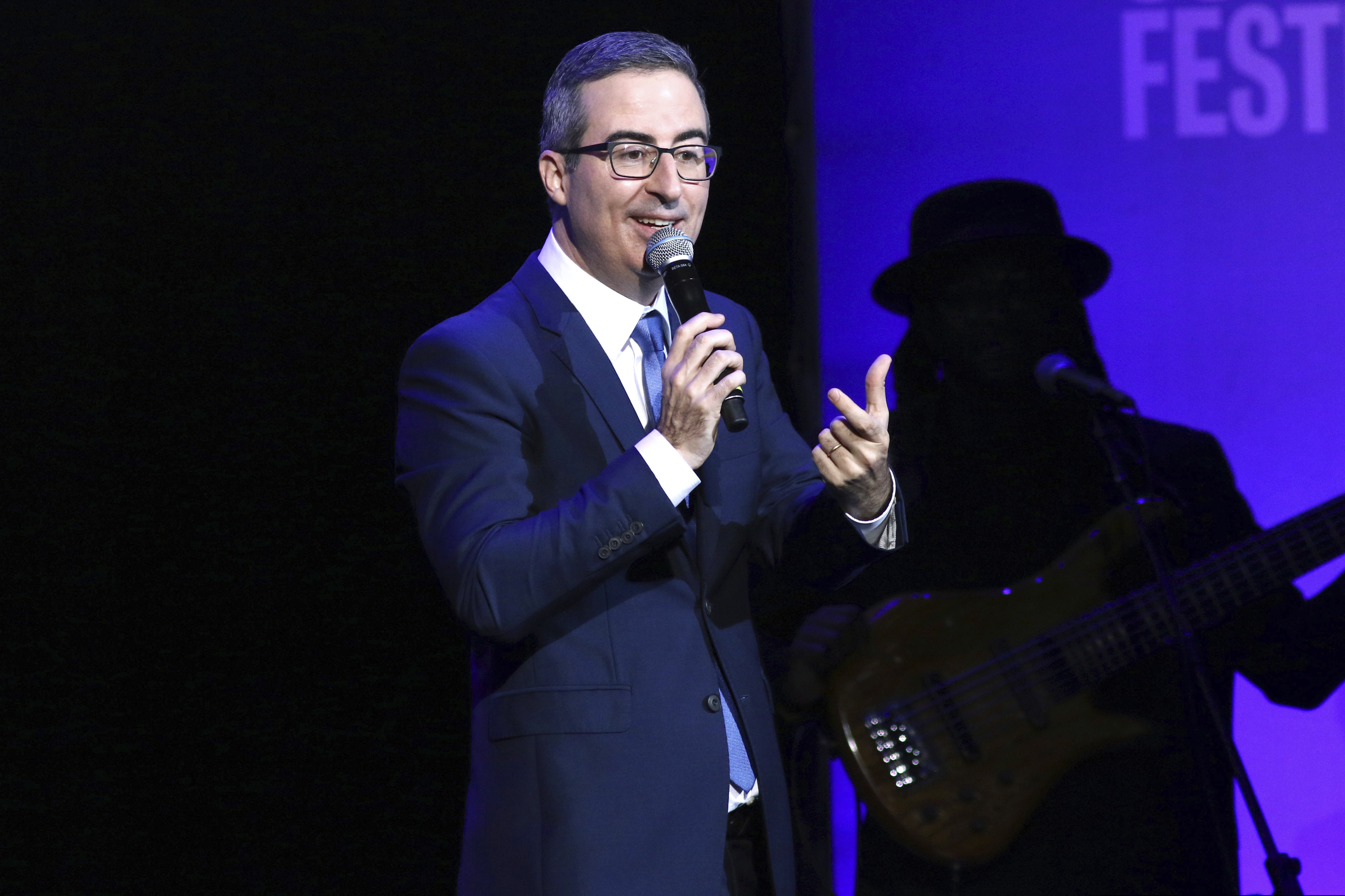 FILE - In this Nov. 4, 2019 file photo, John Oliver performs at the 13th annual Stand Up For Heroes benefit concert in support of the Bob Woodruff Foundation at the Hulu Theater at Madison Square Garden in New York. Danbury, Conn., Mayor Mark Boughton announced a tongue-in-cheek move posted on his Facebook page on Saturday, Aug. 22, 2020, to rename Danbury's local sewage treatment plant after Oliver following the comedian's expletive-filled rant about the city. (Photo by Greg Allen/Invision/AP, File)
