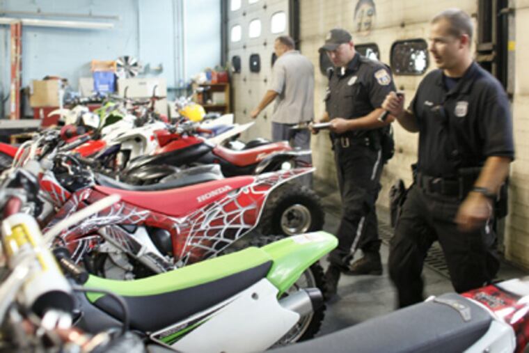 Police with confiscated ATVs and dirt bikes. (Joseph Kaczmarek / For the Daily News)