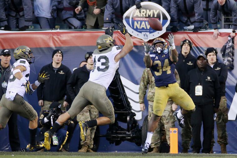 Navy fullback Jamale Carothers (34) makes a touchdown catch in front of Army linebacker Jeremiah Lowery at Lincoln Financial Field.