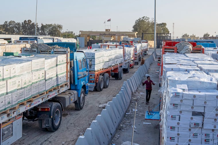 Trucks carrying humanitarian aids line up to enter the Egyptian gate of the Rafah crossing, heading for inspection by Israeli authorities before entering the Gaza Strip, in Rafah, Egypt, Sunday, Feb. 1, 2026.