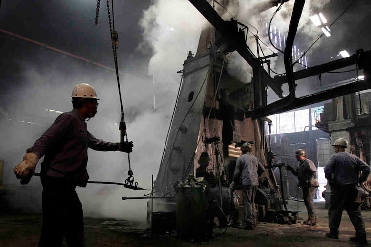 Workers get ready to pull a piece of forged steel from a press at SifCo Industries in Cleveland, Ohio. Manufacturing activity expanded last month at the fastest pace since May.
