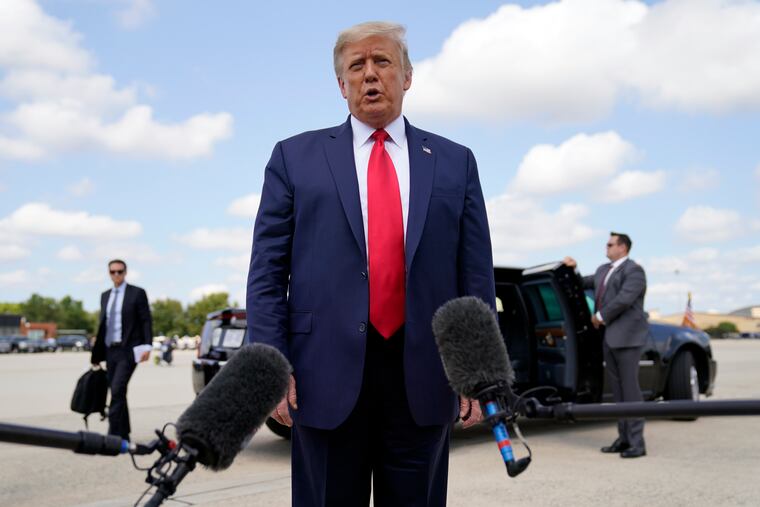 President Donald Trump speaks to reporters before boarding Air Force One for a trip to Jupiter, Fla., on Tuesday.