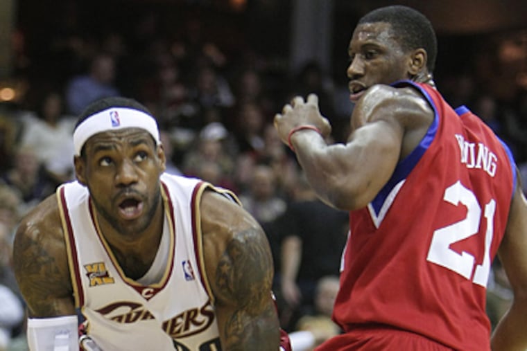 Thaddeus Young defends against LeBron James during the Sixers' 97-91 loss to Cleveland. (AP Photo/Mark Duncan)