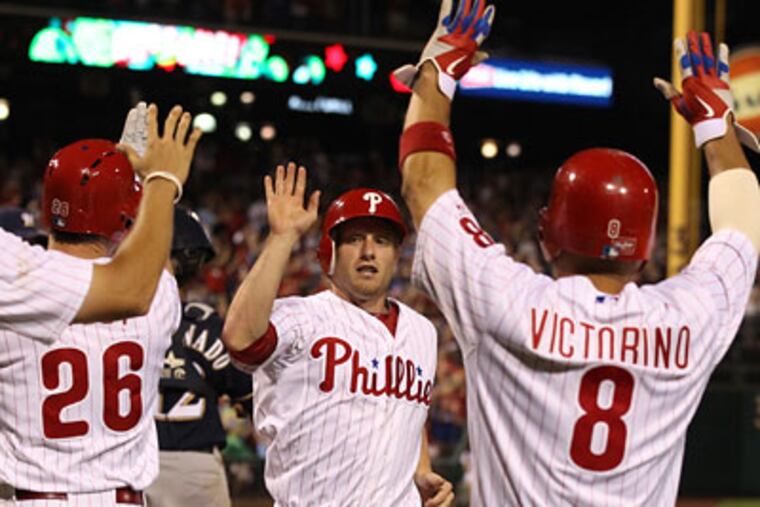 Mike Fontenot is congratulated by teammates after he scored the tying run in the 8th inning. (Ron Cortes/Staff Photographer)