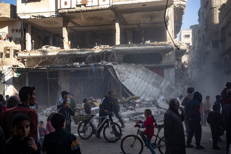 Palestinians check a house destroyed in the Israeli bombardment on Rafah, Gaza Strip, on Monday.