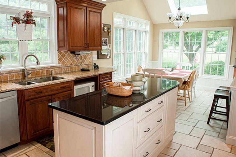 The updated kitchen in the Mankowski's home , which added ceiling height and cabinet space, and is bathed in natural light. (Matthew Hall/Staff Photographer)