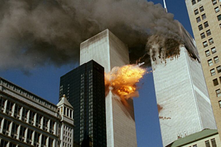 United Airlines Flight 175 collides into the south tower of the World Trade Center as smoke billows from the north tower.