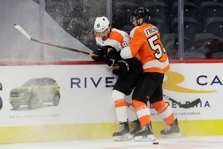 Flyers defenseman Mark Friedman (right), here holding center Morgan Frost during an intrasquad game on Jan. 10, will make his season debut Thursday in Boston.