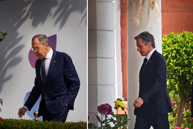 This combination of photos shows U.S. Secretary of State Antony Blinken, right, and Russian Foreign Minister Sergey Lavrov, left, walk to attend second session of the G20 foreign ministers' meeting, respectively, in New Delhi, India, on Thursday.