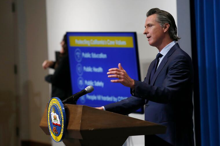 California Gov. Gavin Newsom discusses his revised 2020-2021 state budget during a news conference in Sacramento, Calif. Spending cuts are compounding for schools and state programs, reserve funds are dwindling, and some governors have begun proposing new taxes and fees to shore up state finances shaken by the coronavirus pandemic.