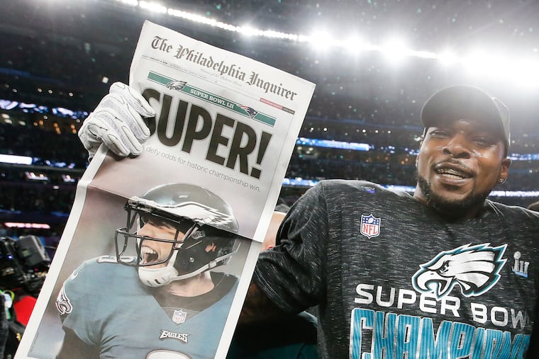 Eagles outside linebacker Nigel Bradham holds the Inquirer after the Eagles beat the New England Patriots in Super Bowl LII.