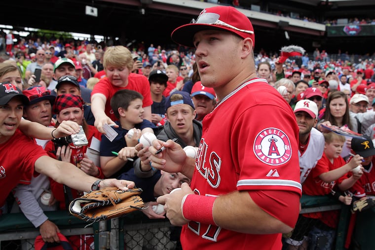 Mike Trout signs autographs during his last trip to Citizens Bank Park in 2014.