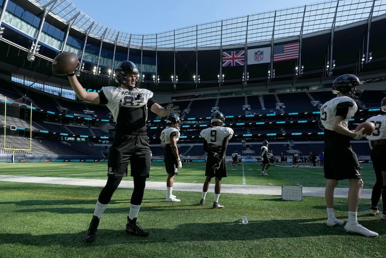 Peter Clarke throws a football along the sideline during an NFL Academy training session at Tottenham Hotspur’s White Hart Lane stadium in London on Oct. 13, 2021.
