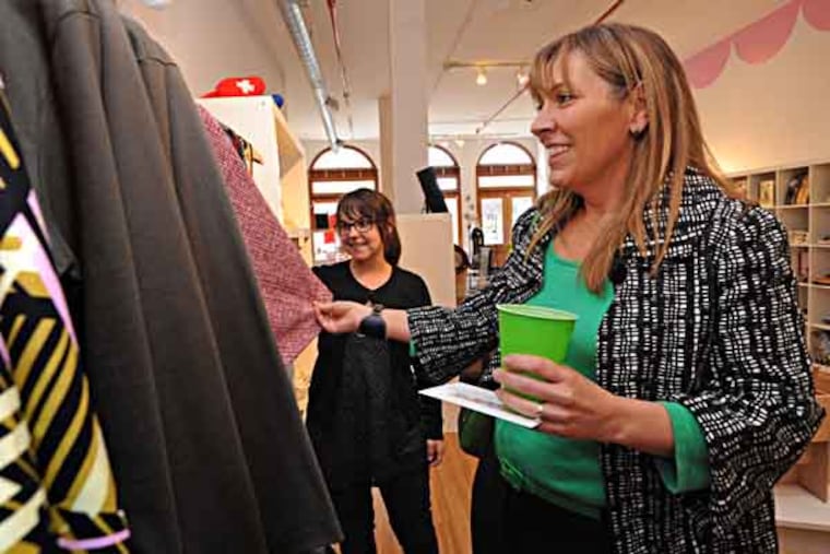 In Philadelphia, Lower Merion's retail recruiter Heidi Tirjan makes the rounds. Here, at Art Star in Northern Liberties, she looks at dresses and talks with Megan Brewster, center. (April Saul / Staff Photographer)