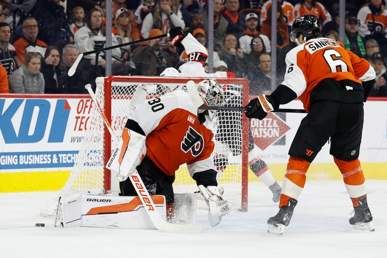 Flyers goaltender Dan Vladar (center) looks back with after Ottawa Senators' Tim Stützle scored the game-winning overtime goal on Thursday.