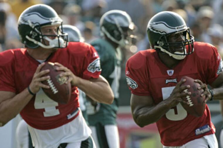 Quarterbacks Donovan McNabb, right, and Kevin Kolb drop back during drills at Eagles training camp. (Michael Perez/Staff Photographer)