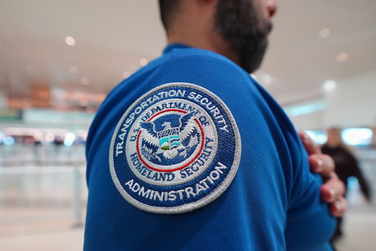 A TSA agent wears a U.S. Department of Homeland Security patch on his uniform at Love Field Airport in Dallas, Wednesday, Feb. 18, 2026.